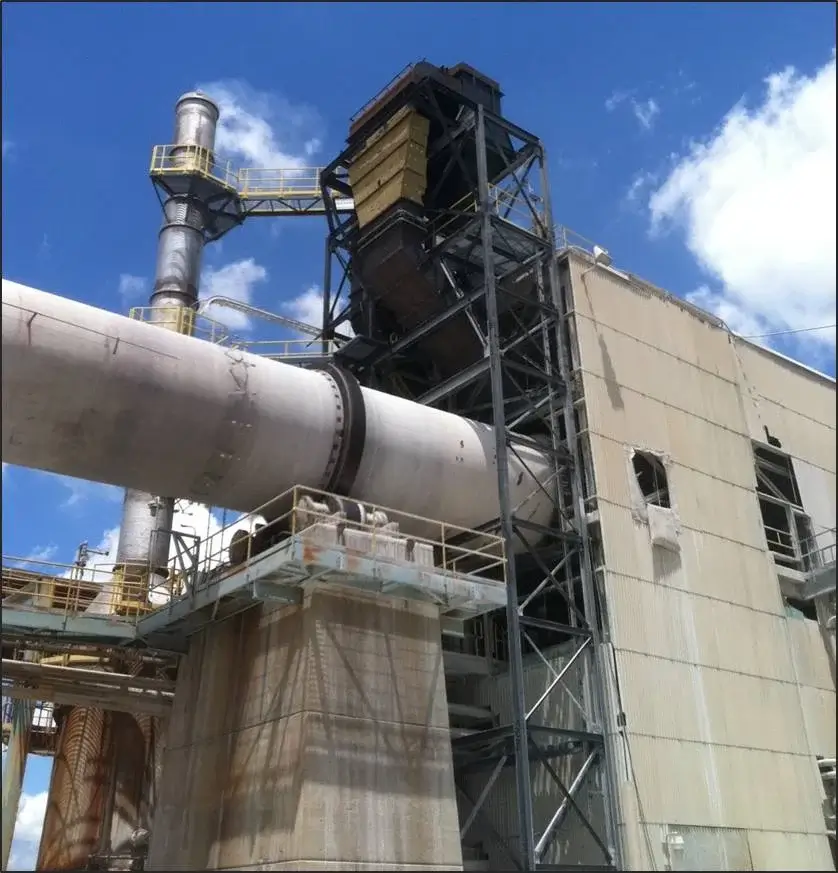 Industrial structure with large pipes against blue sky.