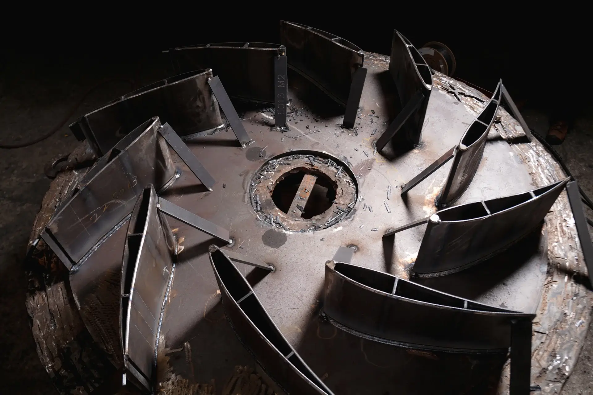 Industrial fan components arranged on metal surface.