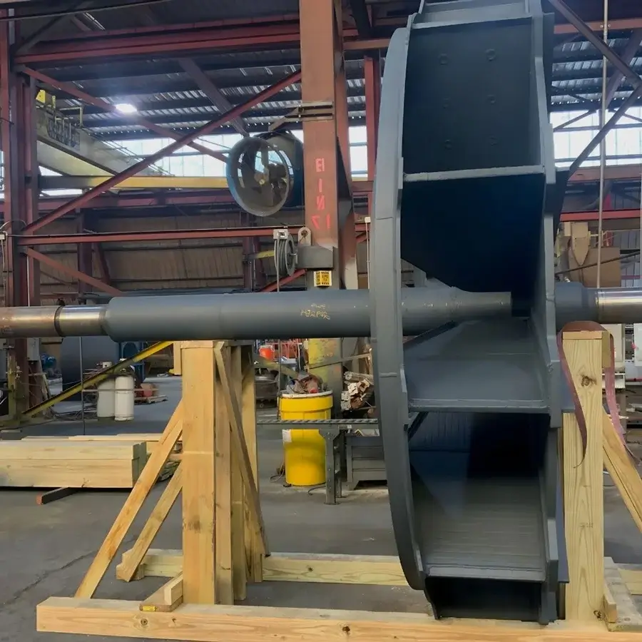 Large industrial fan assembly in a workshop setting.