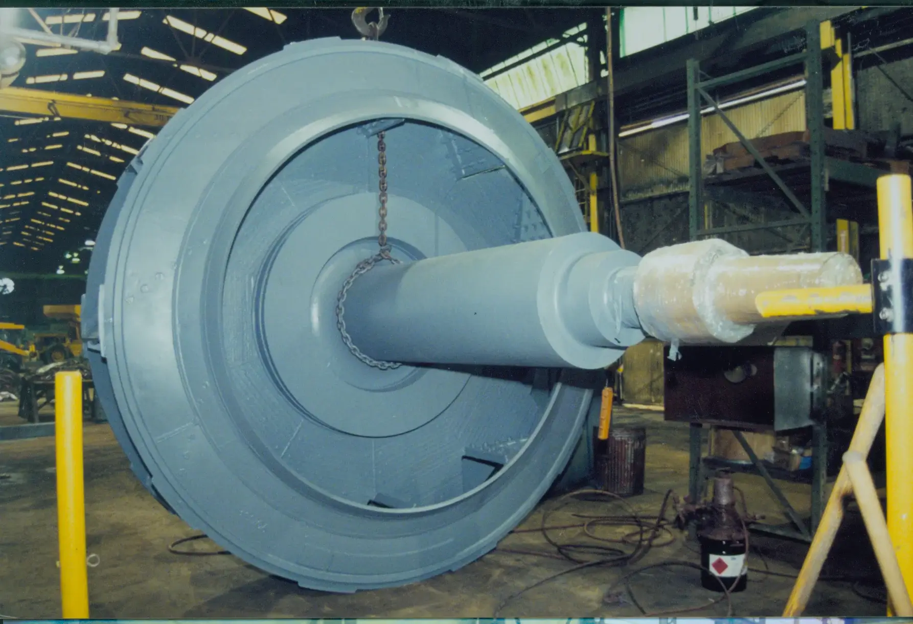 Large industrial fan suspended by a chain.