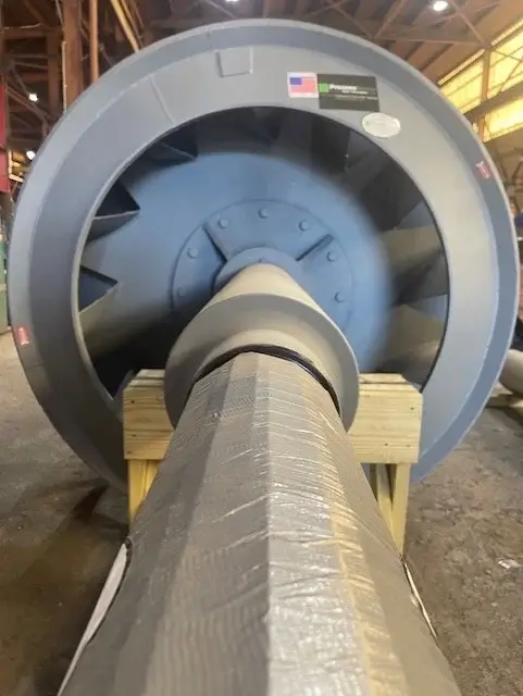 Large industrial fan inside manufacturing facility, perspective view.