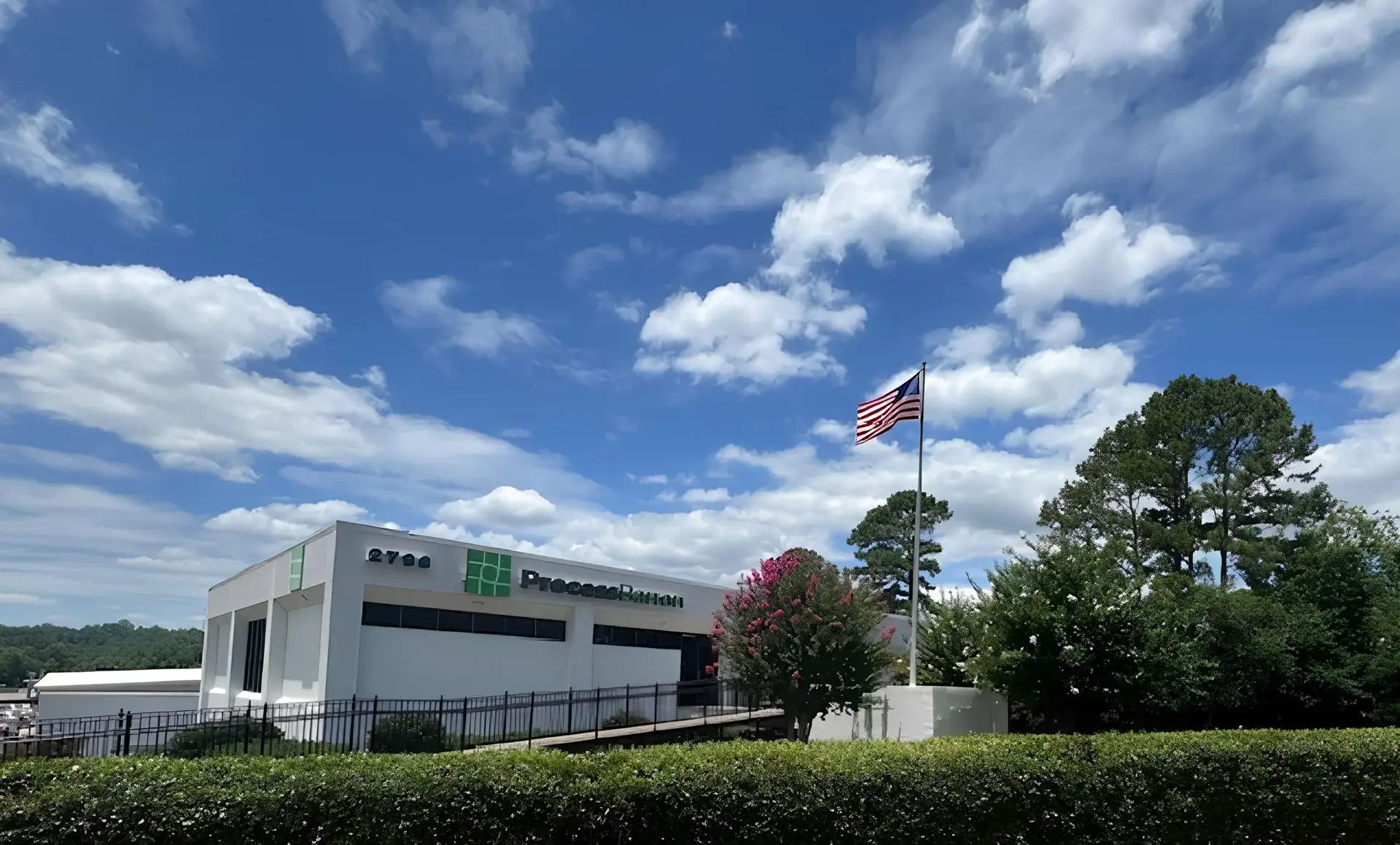 American flag flying outside Process Barron building.