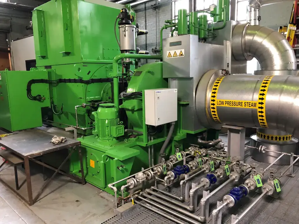 Green industrial machinery handling low-pressure steam safely.