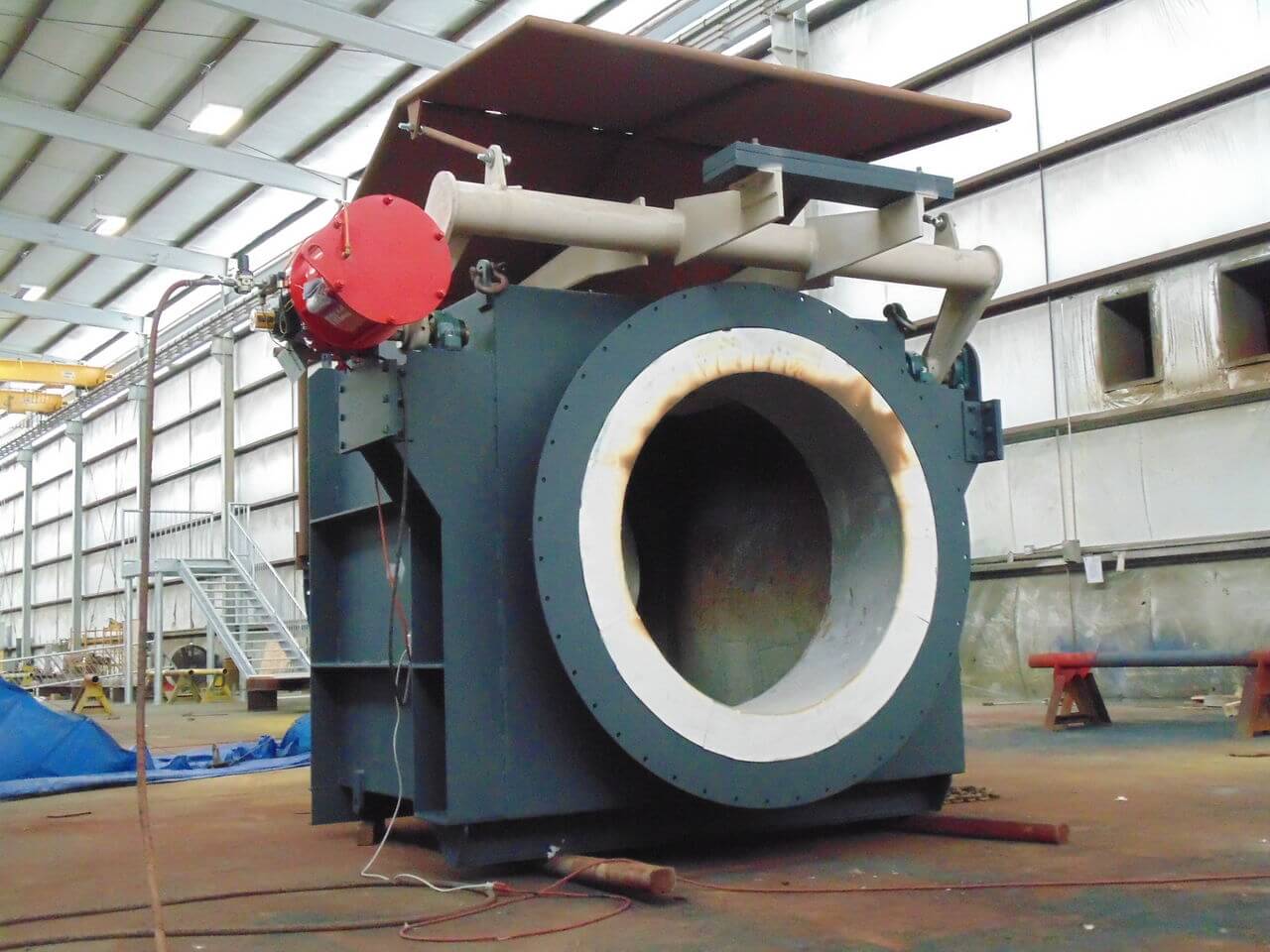 Large industrial fan inside manufacturing facility.