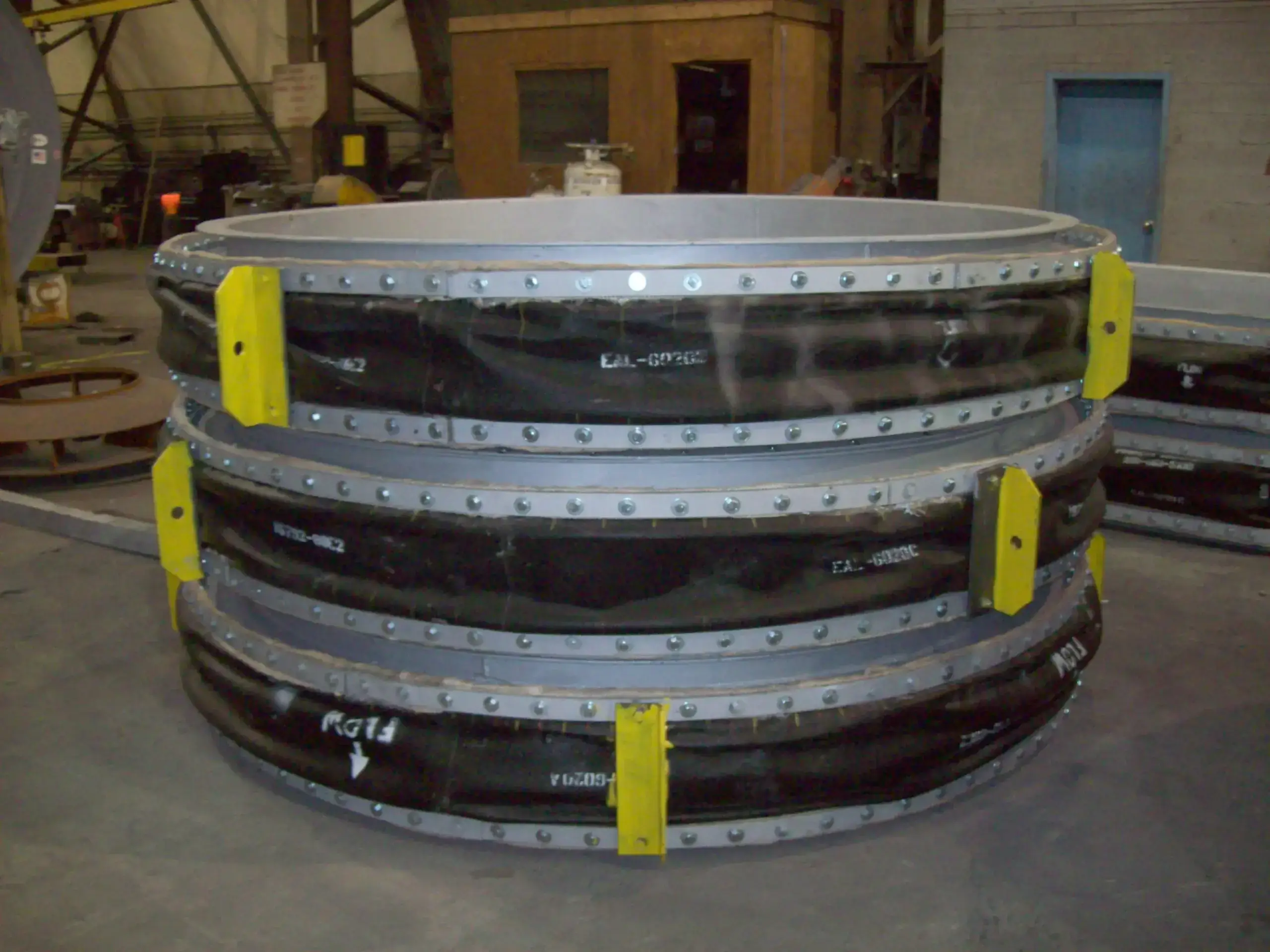 Large industrial fan casing on factory floor.