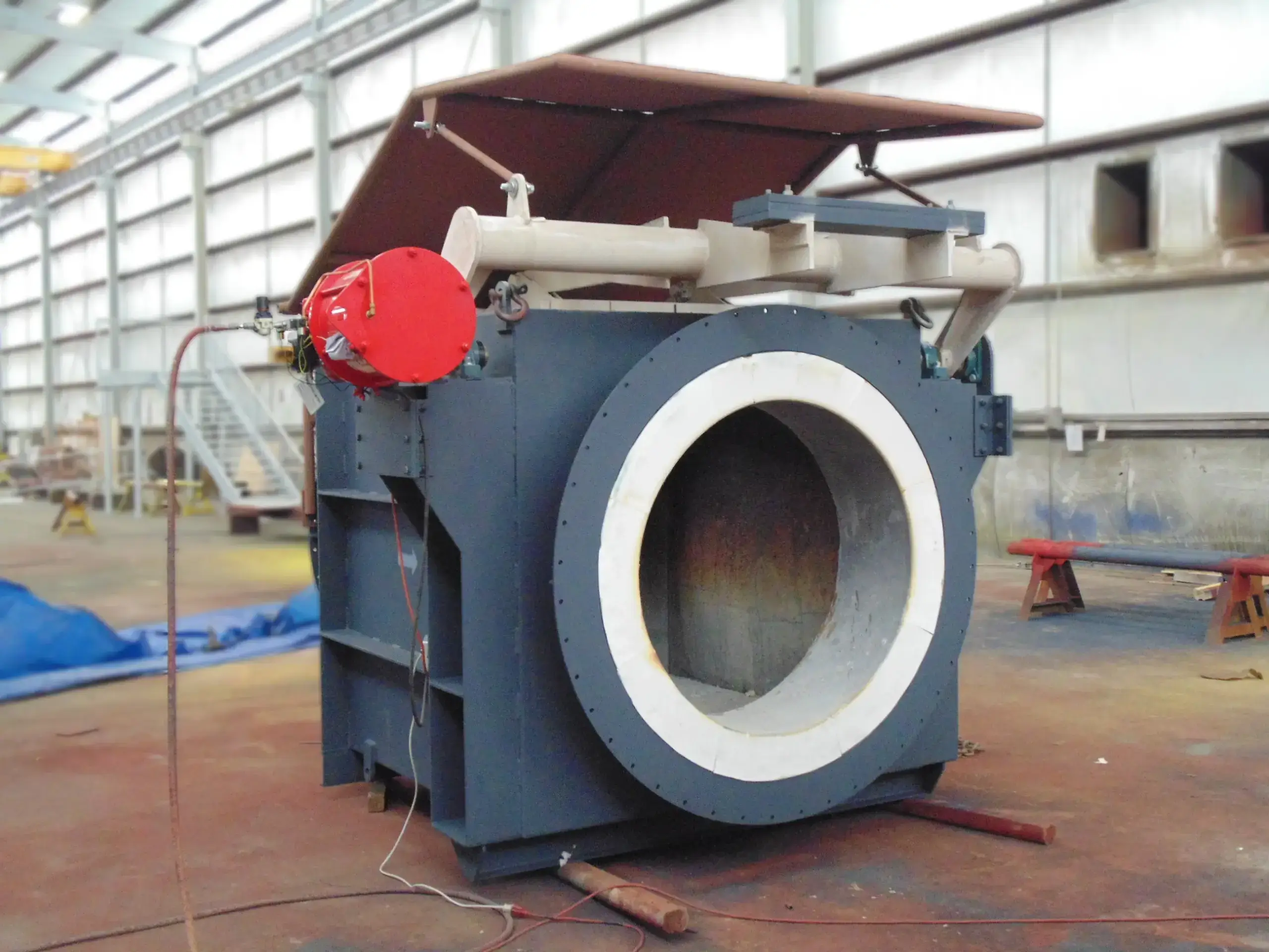 Industrial fan in warehouse, ready for installation.