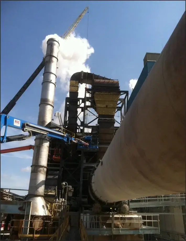 Industrial equipment with large piping and visible steam exhaust.