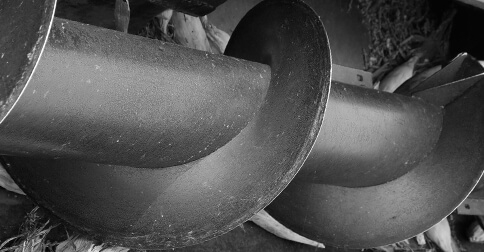 Close-up of large industrial screw conveyor.