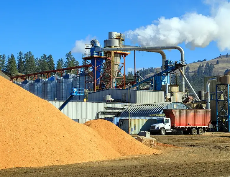 Industrial facility processing materials with truck and conveyor system.