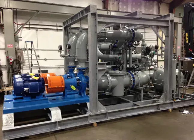 Industrial machinery system with pipes and motors indoors.