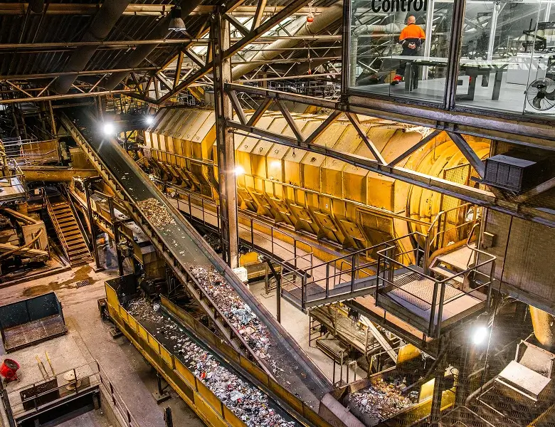 Industrial conveyer belt transporting materials in large facility.