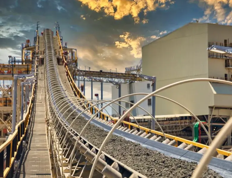 Conveyor belt transporting materials at industrial facility.