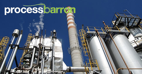 Industrial facility with smokestack and metal structures.