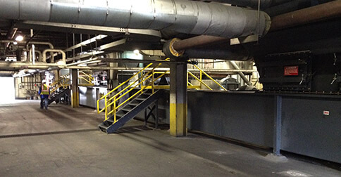 Industrial facility with large ducts and machinery.