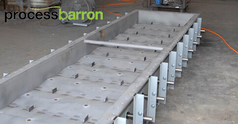 Industrial ash handling equipment in manufacturing setting.