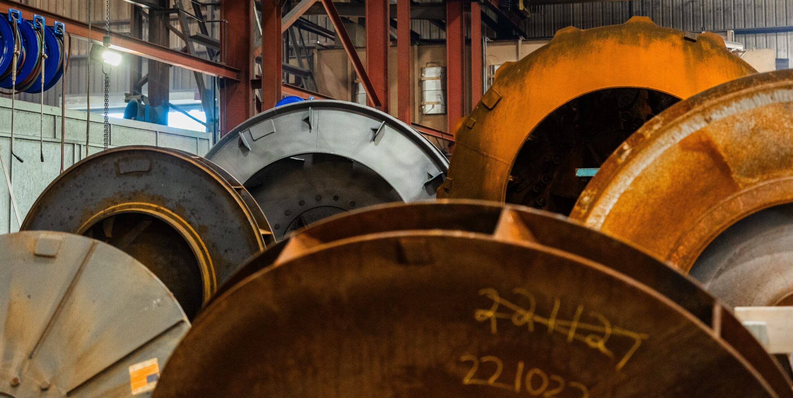 Industrial fan components in warehouse, stacked and arranged.