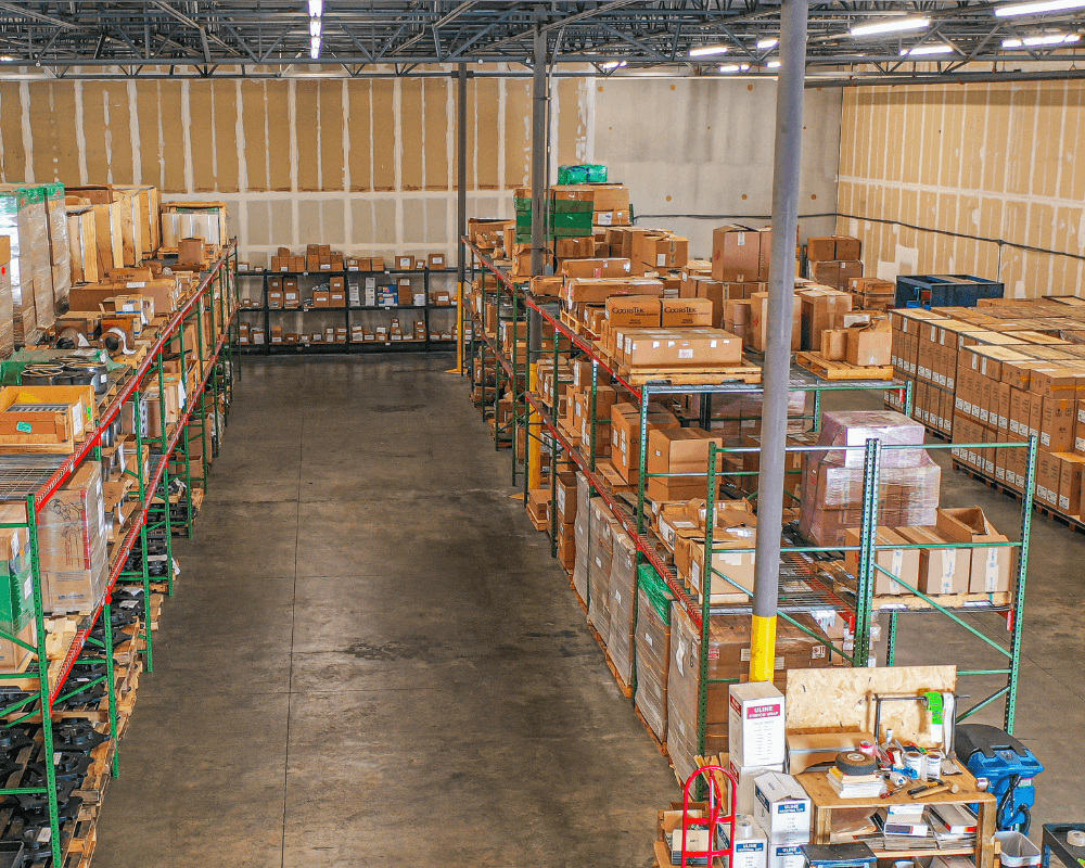 Warehouse storage with packed boxes on metal shelves.