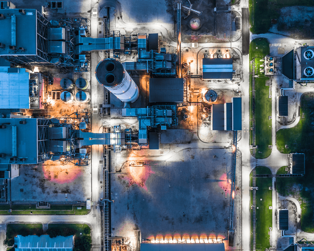 Aerial view of illuminated industrial complex at night.