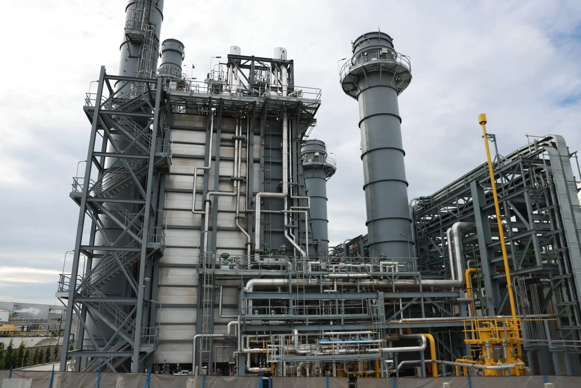 Industrial facility with large pipes and steel structures.