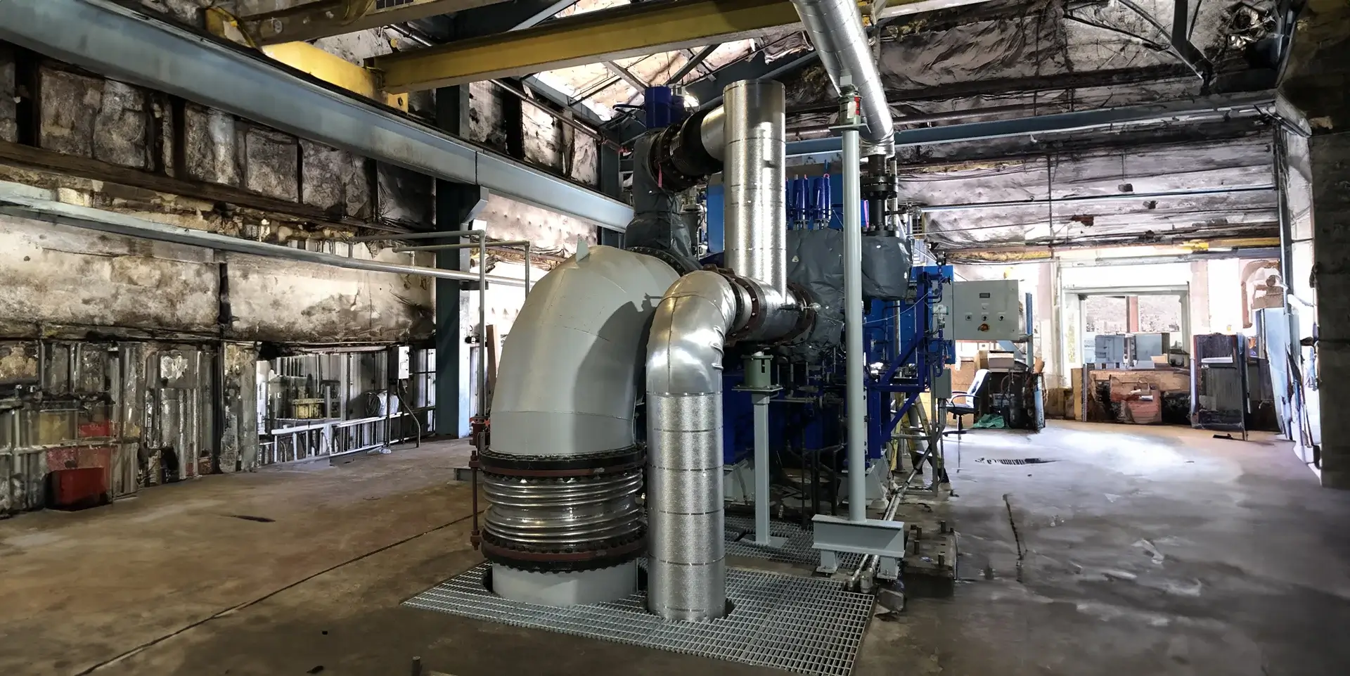 Industrial facility featuring large metal piping system.